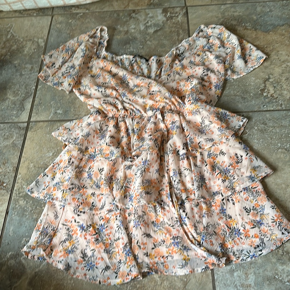 Orange flower dress with form fitting waist flowy bottom and sleeves.